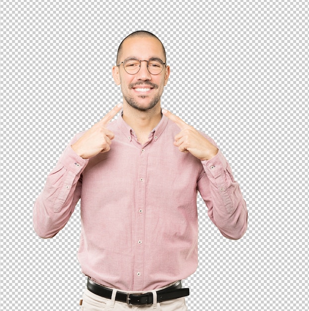 Young man pointing to his teeth