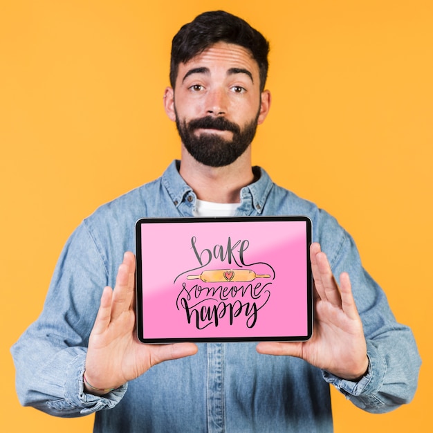 Young man showing a tablet mock up