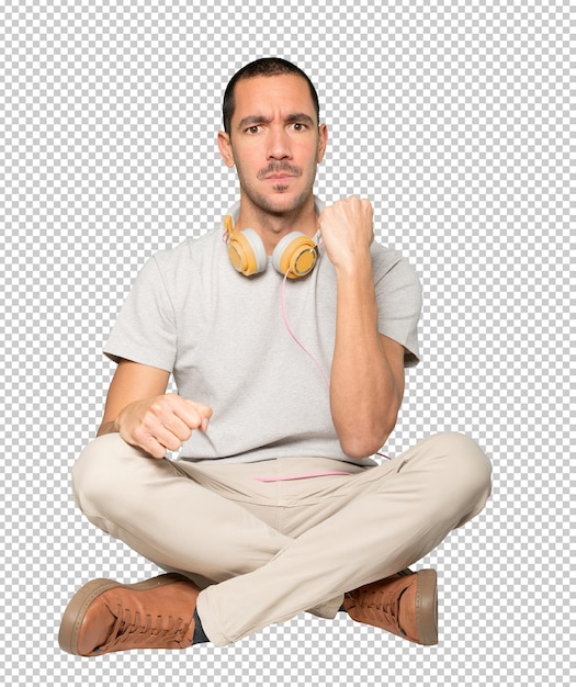 PSD young man in sitting position with a celebration gesture