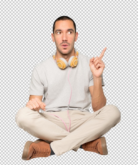 PSD young man in sitting position with a finger pointing gesture