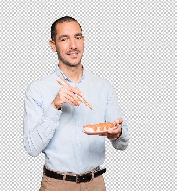 PSD young man using chopsticks to eat sushi