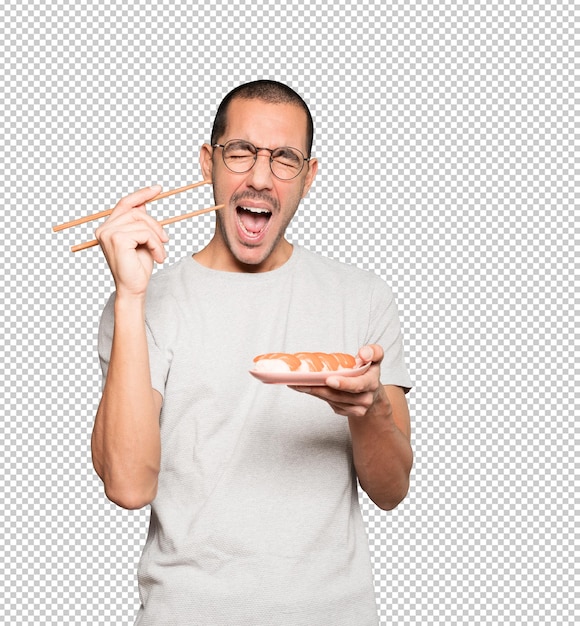 PSD young man using chopsticks to eat sushi