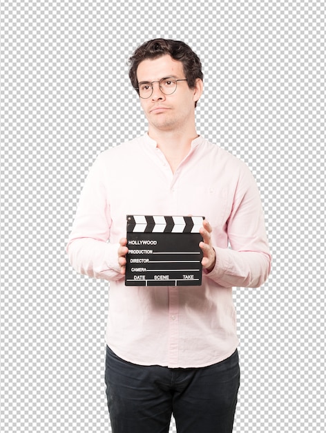 Young man using a clapperboard