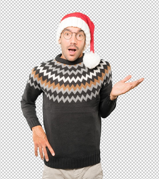 Young man wearing a christmas hat while gesturing isolated