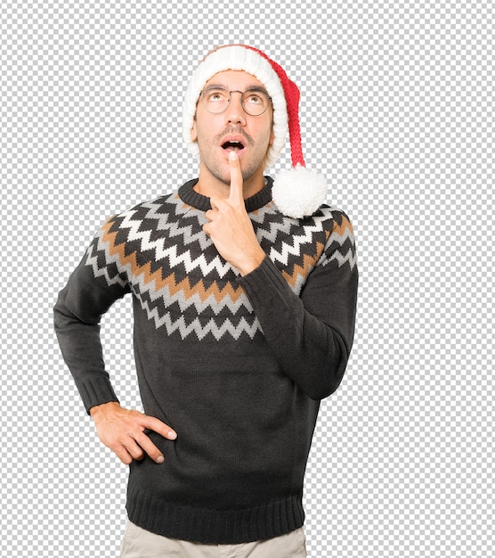 Young man wearing a christmas hat while gesturing isolated