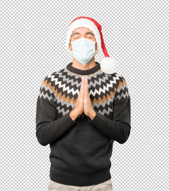 Young man wearing a christmas hat while gesturing isolated