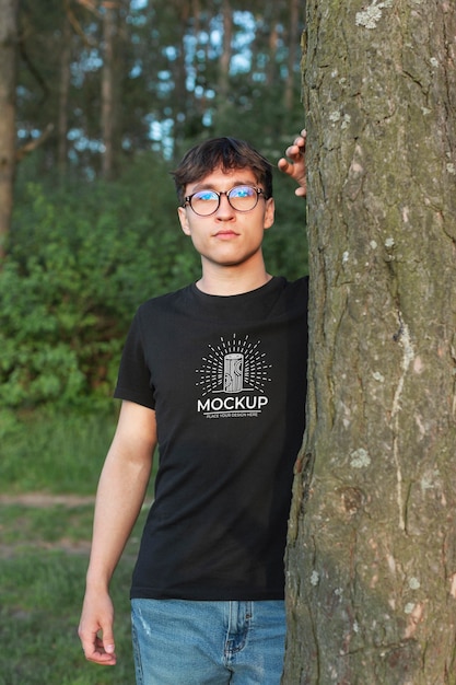 Young man wearing a mock-up t-shirt in the forest