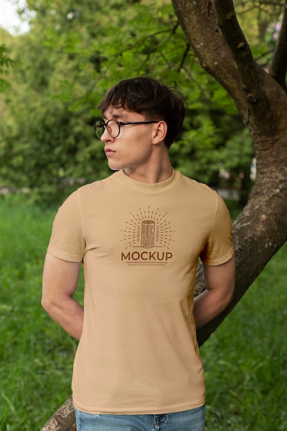 Young man wearing a mock-up t-shirt outdoors