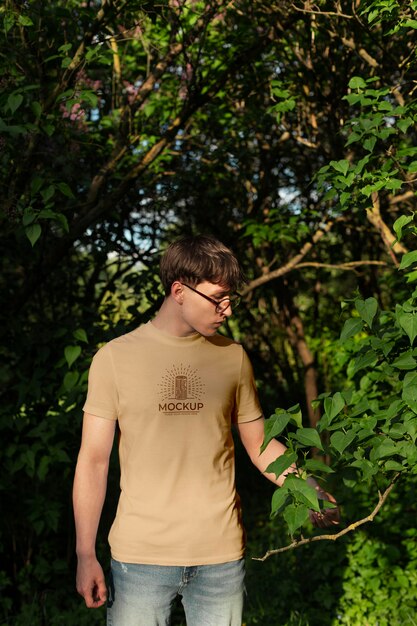 Young man wearing a mock-up t-shirt outdoors