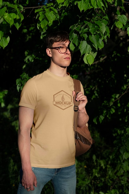 PSD young man wearing a mock-up t-shirt outdoors