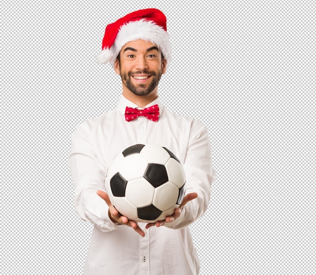 Young man wearing a santa claus hat on christmas day
