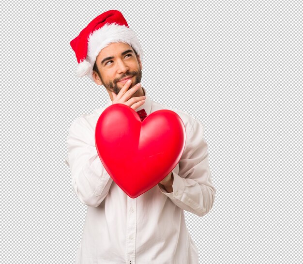 Young man wearing a santa claus hat on christmas day