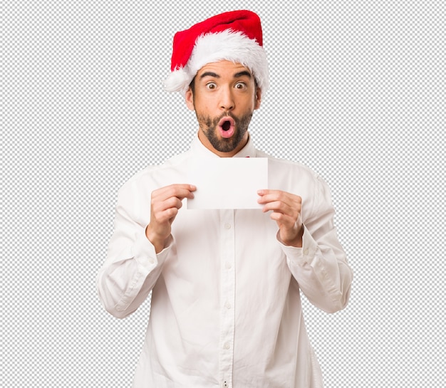 Young man wearing a santa claus hat on Christmas day