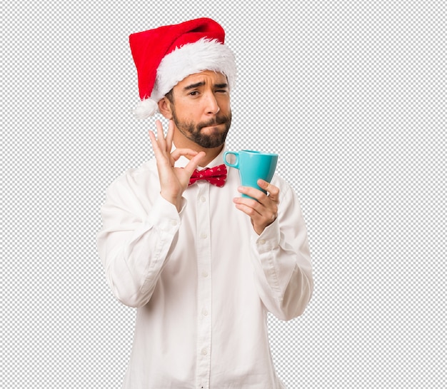 Young man wearing a santa claus hat on christmas day