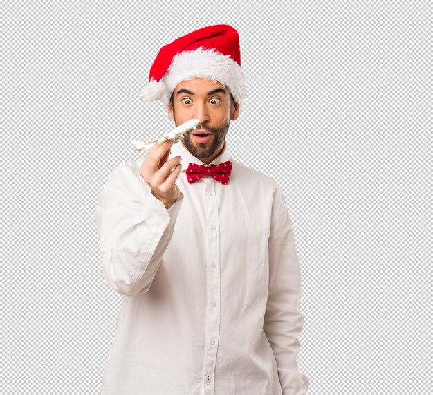 Young man wearing a santa claus hat on Christmas day