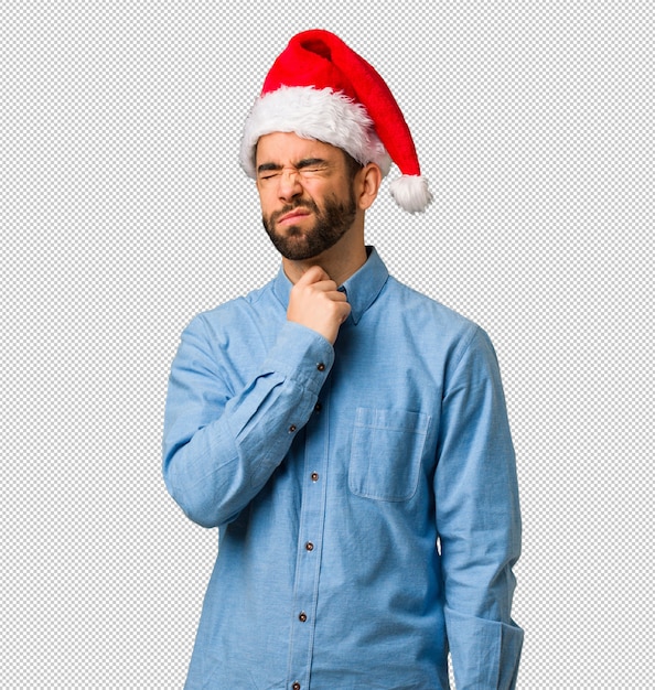 Young man wearing santa hat coughing, sick due a virus or infection