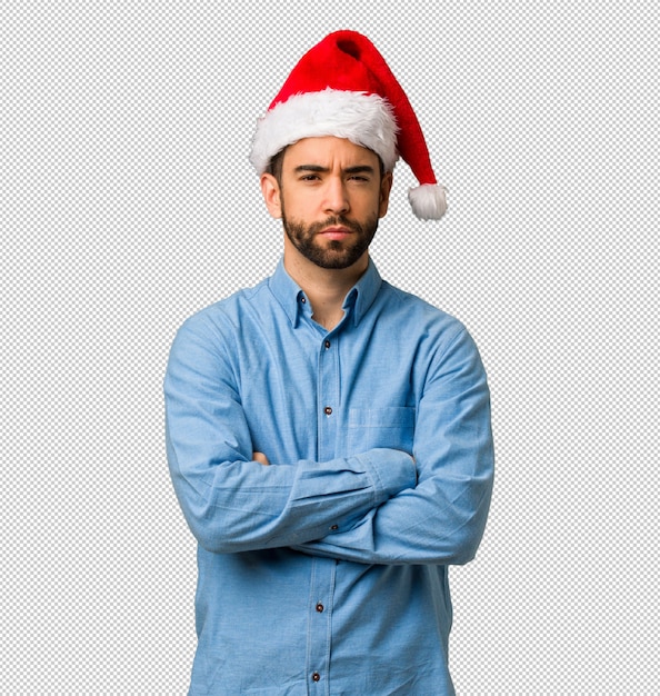 PSD young man wearing santa hat crossing arms relaxed