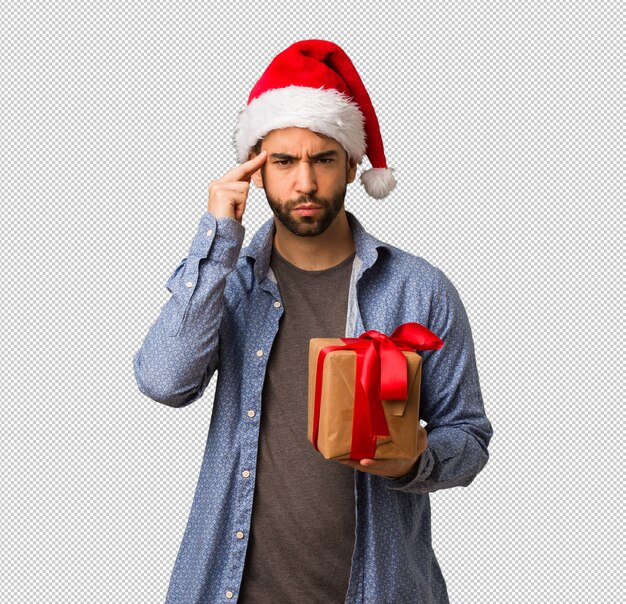 Young man wearing santa hat doing a concentration gesture