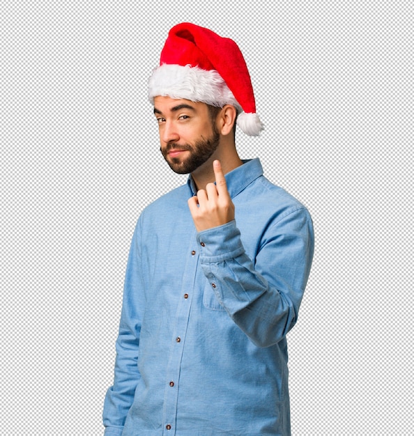 Young man wearing santa hat inviting to come