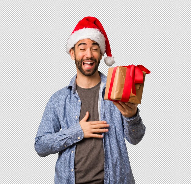 Young man wearing santa hat laughing and having fun