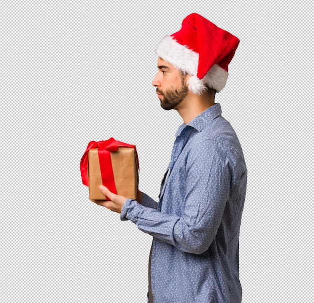 Giovane uomo che indossa il cappello santa sul lato cercando di fronte