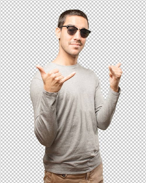 Young man wearing sunglasses and doing gestures
