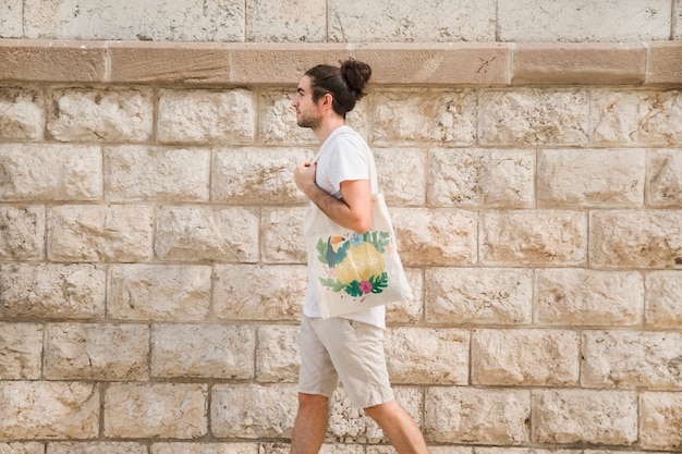 PSD young man with bag mockup