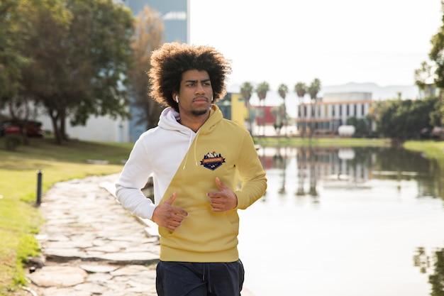 Young man with hoodie running outdoor