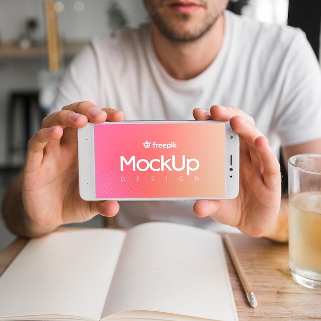 young man with a smartphone mockup