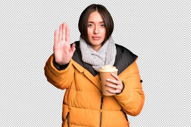 Young pretty hispanic woman with a take away coffee and wearing an anorak