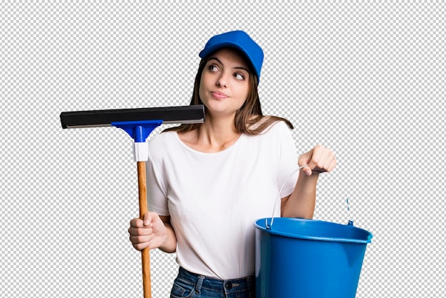 Young pretty woman housekeeper cleaning the windows