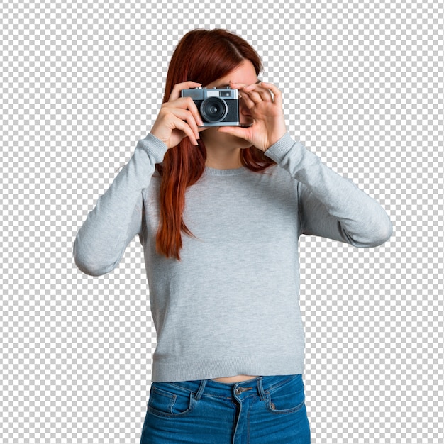 PSD young redhead girl holding a camera