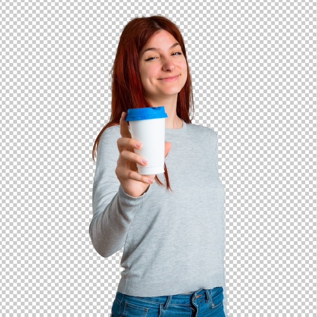 Young redhead girl holding hot coffee in takeaway paper cup