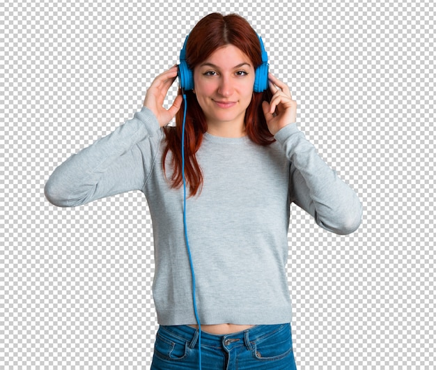 PSD young redhead girl listening to music with headphones