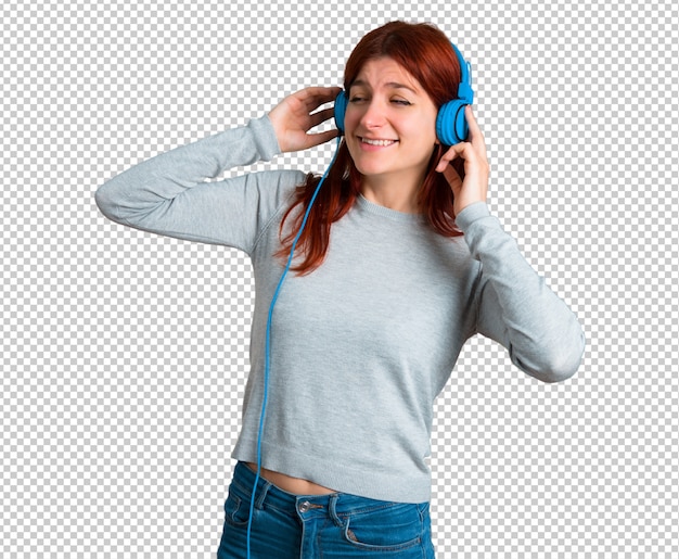 PSD young redhead girl listening to music with headphones