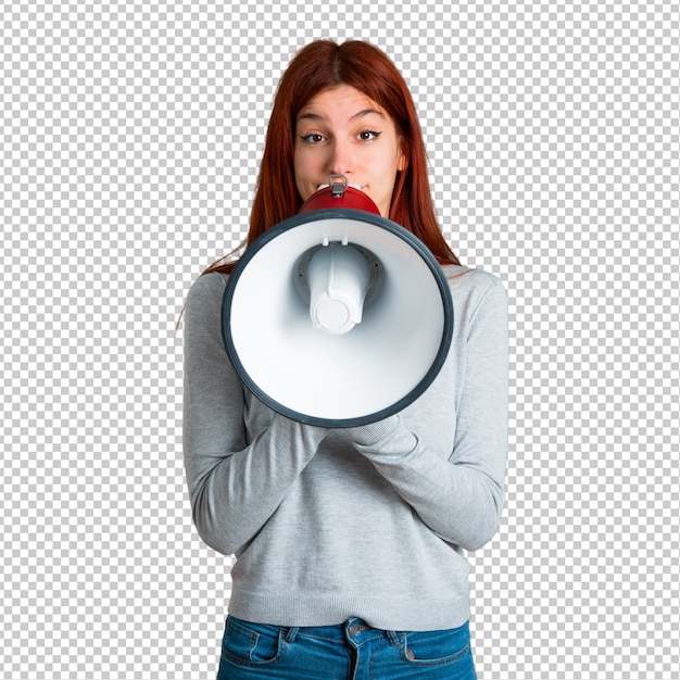 Young redhead girl shouting through a megaphone to announce something