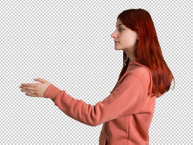 PSD young redhead girl with pink sweatshirt handshaking after good deal