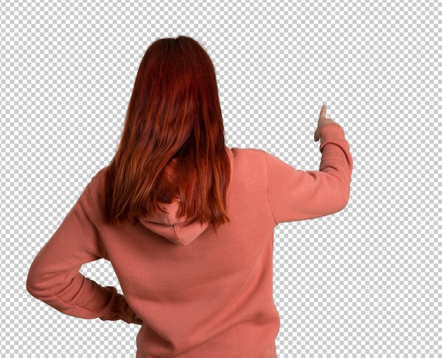 PSD young redhead girl with pink sweatshirt pointing back with the index finger