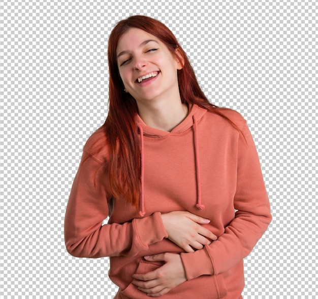 PSD young redhead girl with pink sweatshirt smiling a lot while putting hands on chest