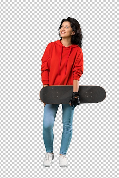 Young skater woman looking up while smiling