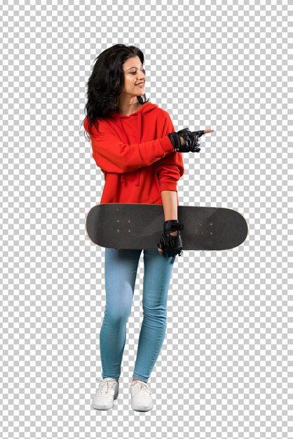 Young skater woman pointing to the side to present a product