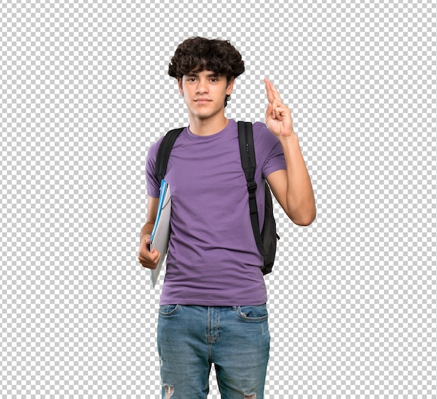 Young student man with fingers crossing and wishing the best