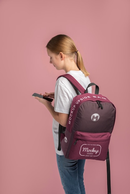 Young teenage girl carrying a backpack mock-up