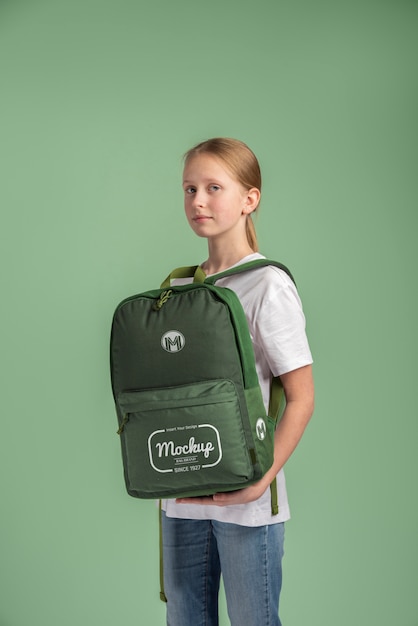 Young teenage girl carrying a backpack mock-up