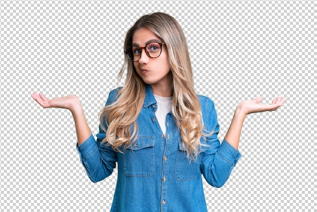 Young uruguayan woman over isolated background having doubts while raising hands