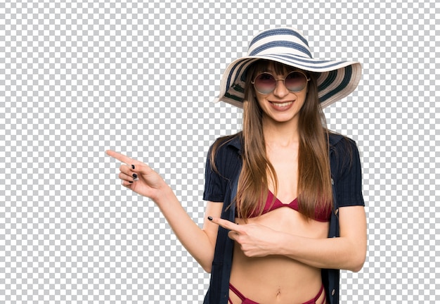 Young woman in bikini pointing finger to the side