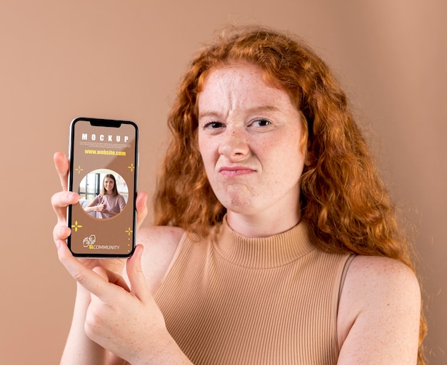 PSD young woman holding a smartphone mock-up