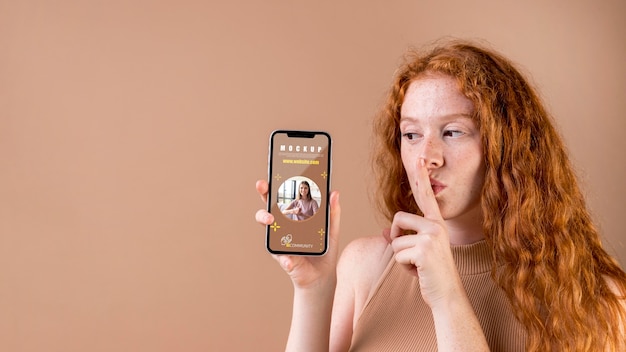 PSD young woman holding a smartphone mock-up