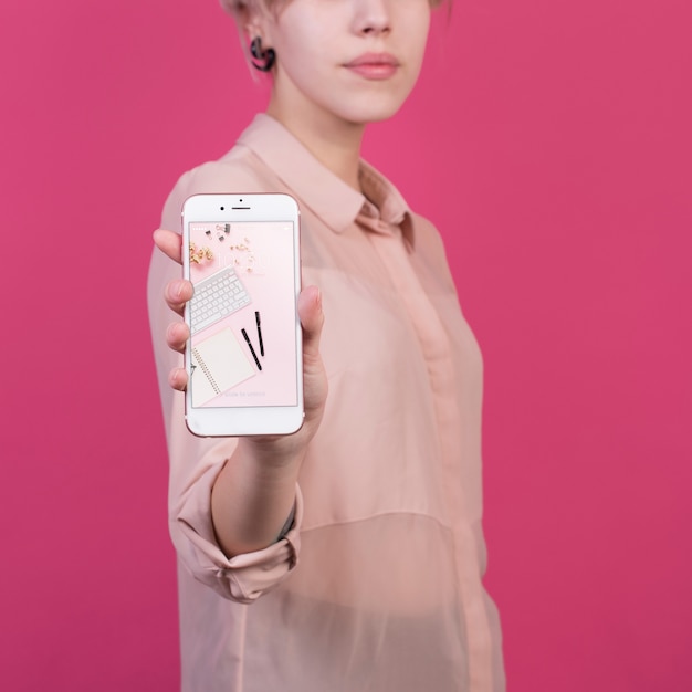 PSD young woman holding smartphone mockup