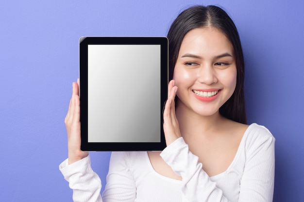 Young woman is holding tablet mockup